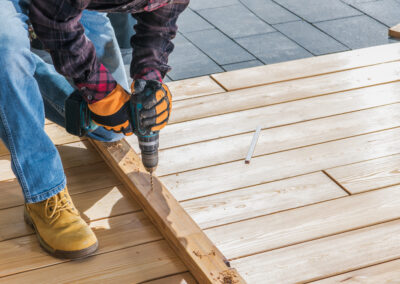 Construction Job. Men Drill Holes Inside Wood Planks. Small House Woodwork. Close Up Photo.