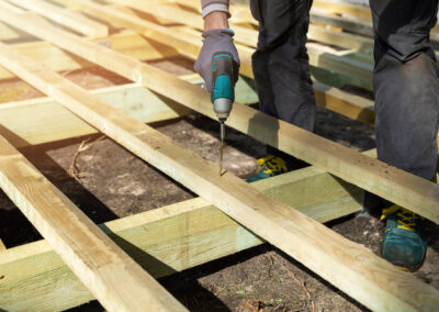 man building wooden frame for patio deck