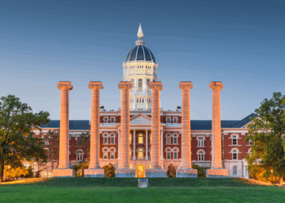 Front view of Jesse Hall and The Columns at the University of Missouri (Mizzou) in Columbia, Missouri, at twilight, highlighting institutional and educational project experience.